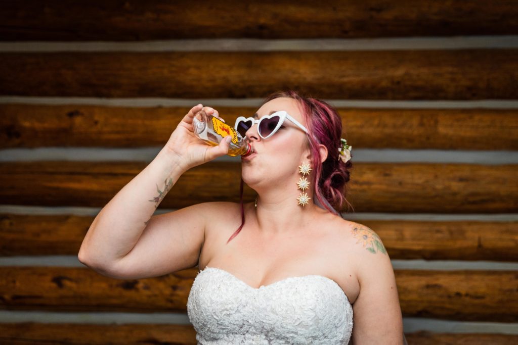 Bride taking a swing from a Fireball flask