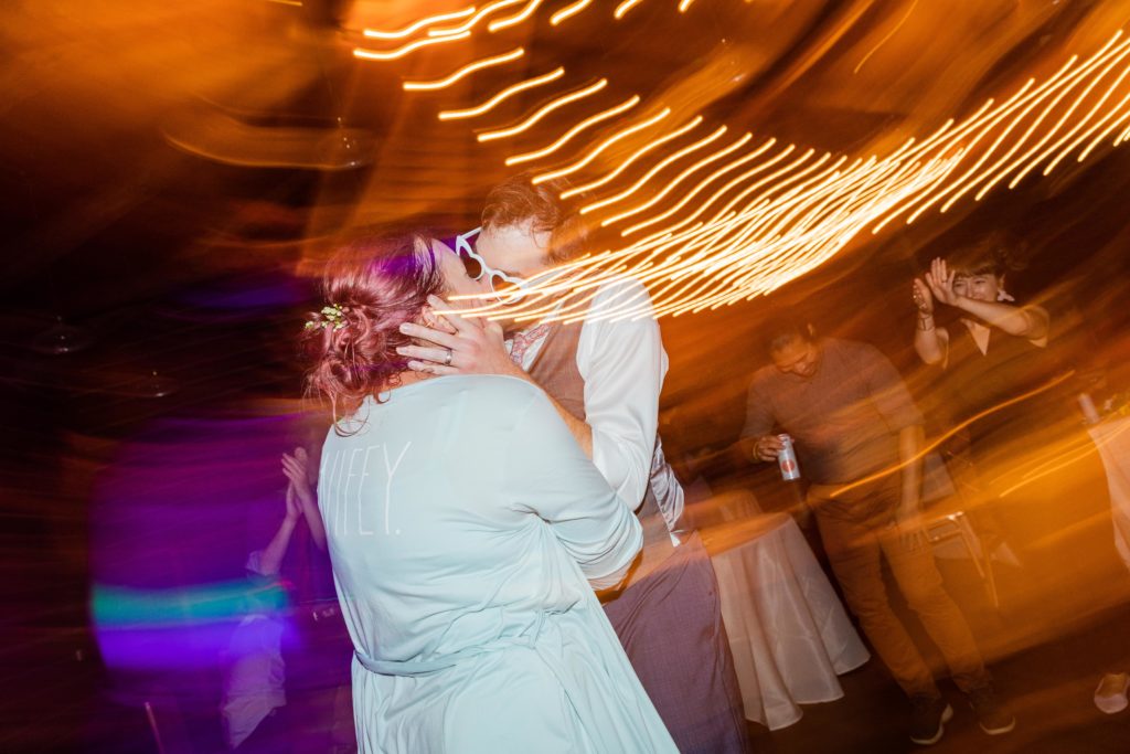 Bride and groom kissing on the dance floor at their Dao House Wedding
