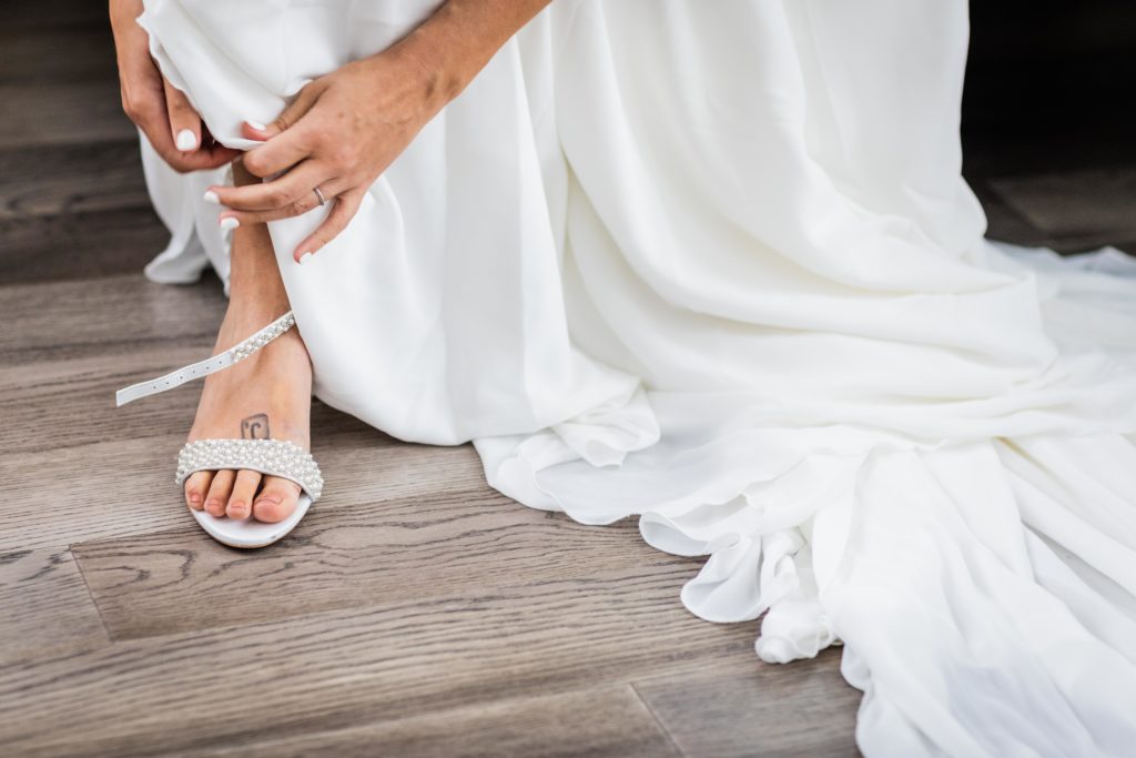 Bride putting her shoes on at the Robey