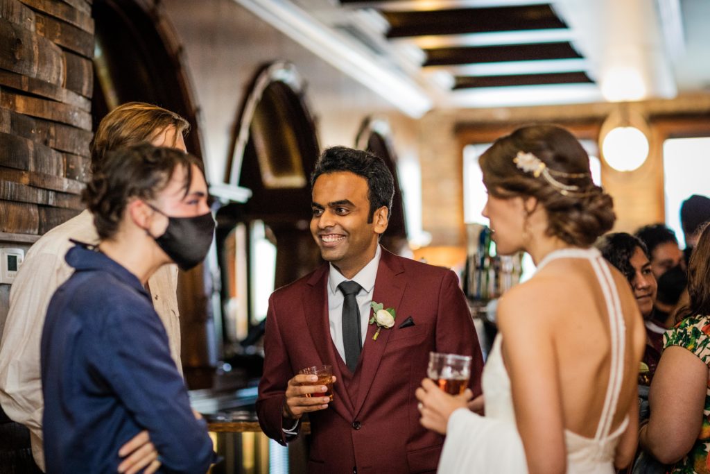 Groom chatting with guests at his Revolution Brewing Wedding