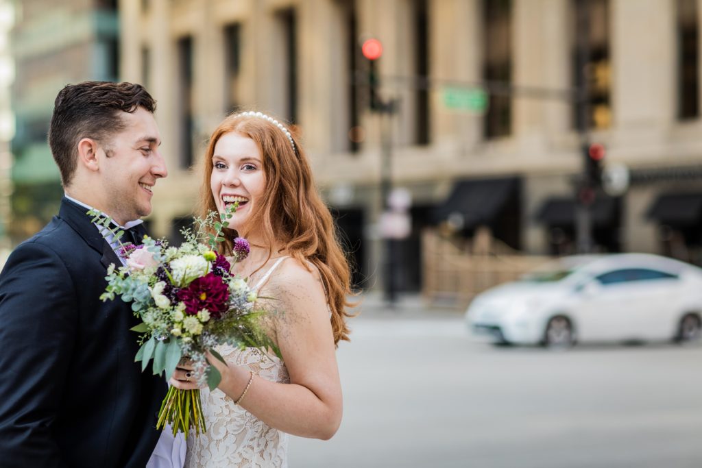 Bride smiling and laughing on a downtown corner in Chicago