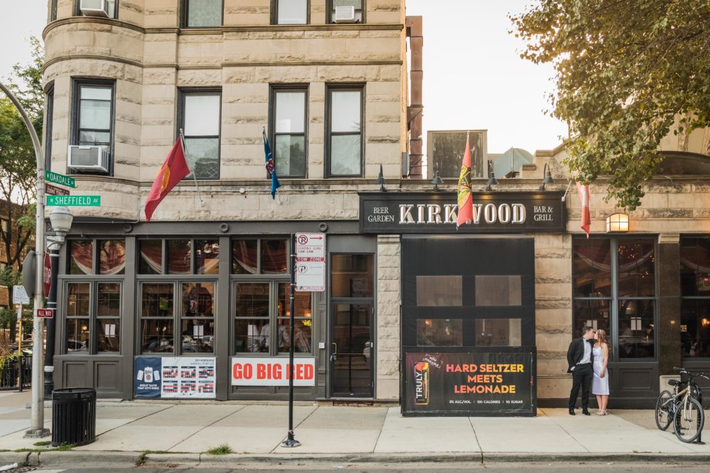 Couple kissing in front of Kirkwood Bar in Chicago