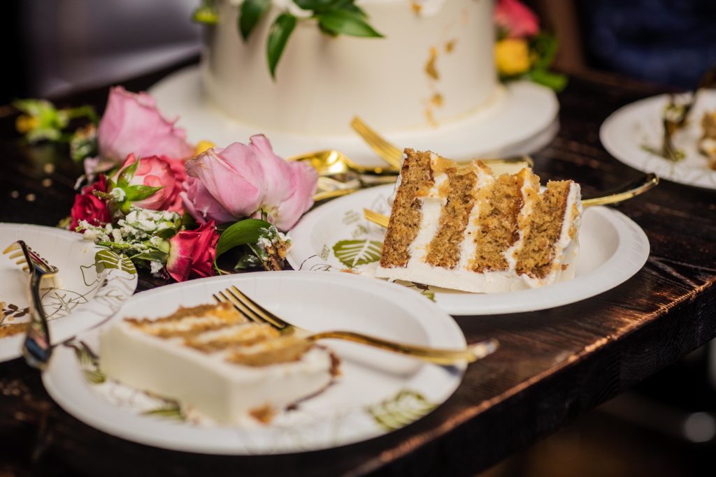 Carrot cake cut into slices and on paper plates from Bittersweet Pastry Shop