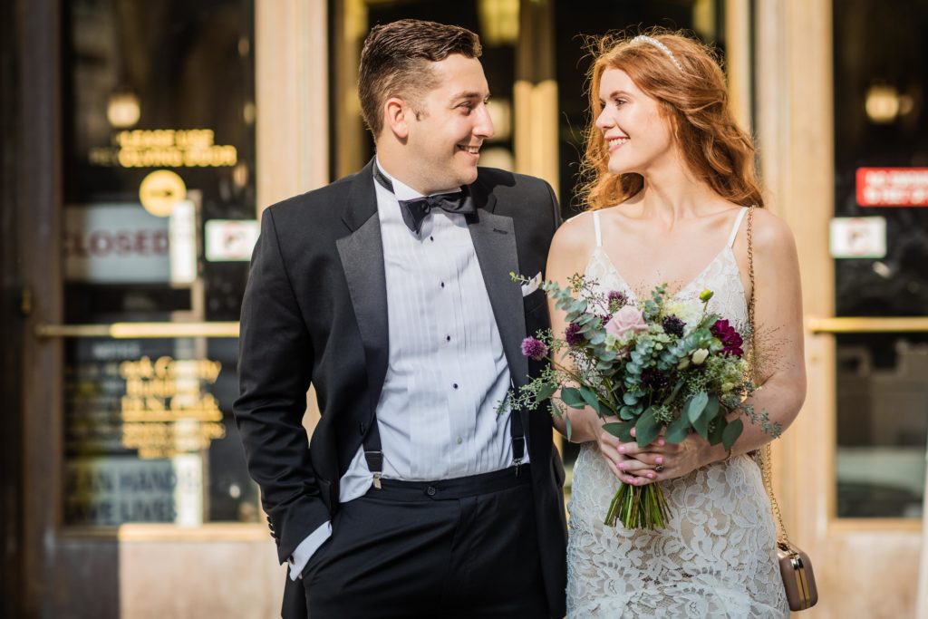 Couple smiling at each other before their City Hall wedding