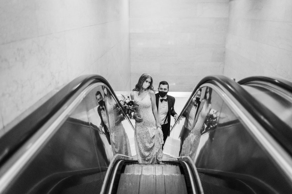 Couple coming up the escalator after their Chicago City Hall wedding 
