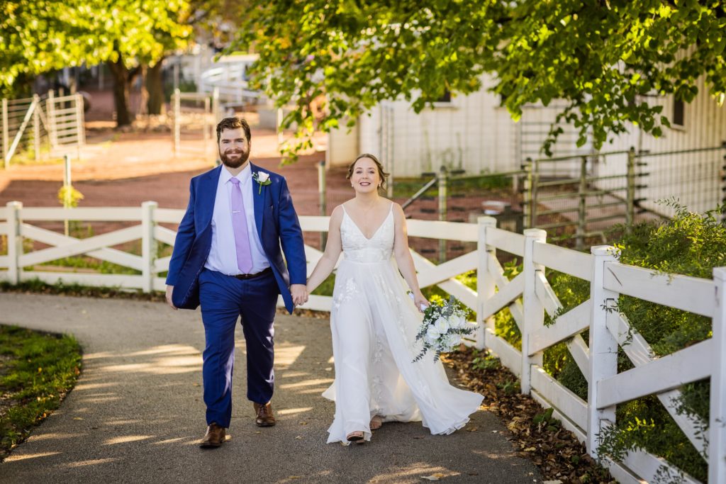 Bride and groom walking together while holding hands in Lincoln Park before their Lincoln Park Conservatory Wedding