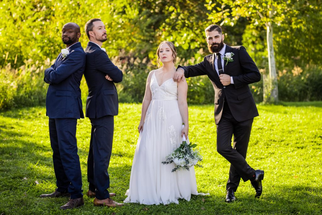 Bride posing with the groomsmen before her Lincoln Park Conservatory Wedding