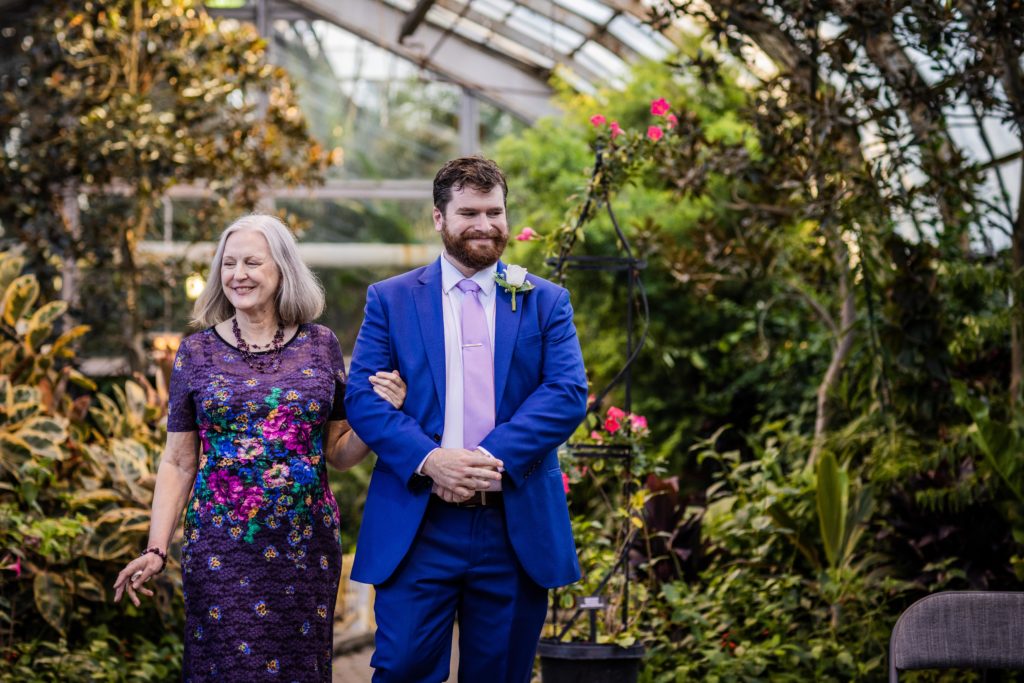 Groom and his mother walking down the aisle