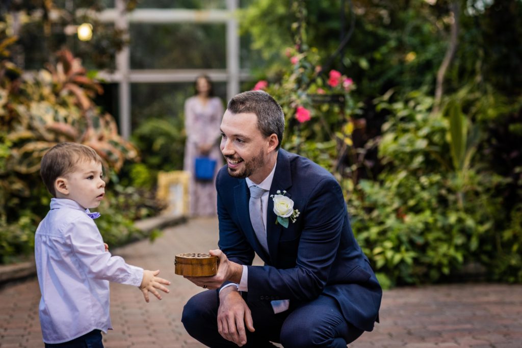 Best man being given the ring by the ring bearer