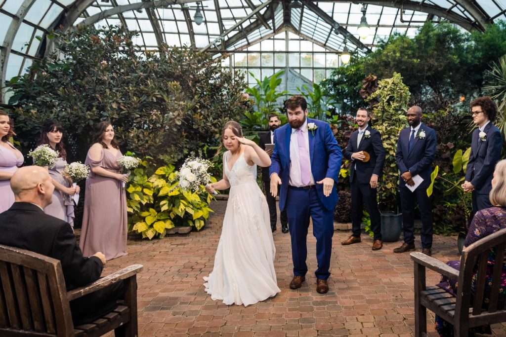 Couple walking back up the aisle after their Lincoln Park Conservatory wedding ceremony