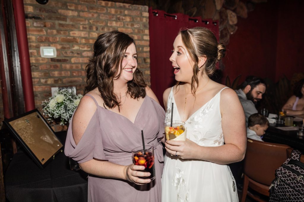 Bride laughing with the maid of honor