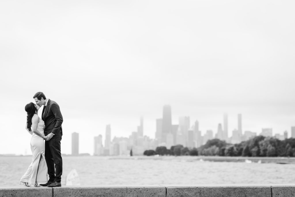 Bride and groom kissing with the Chicago Skyline behind them after their elopement in Chicago