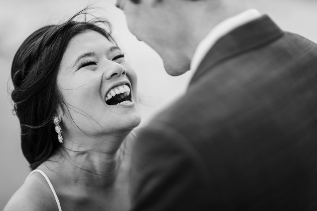 Bride laughing with the groom after their elopement in Chicago at Belmont Harbor