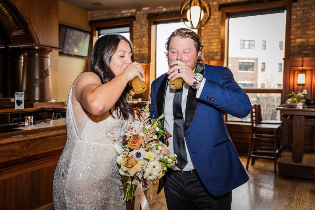 Couple drinks beer after getting married at their Revolution Brewing Wedding