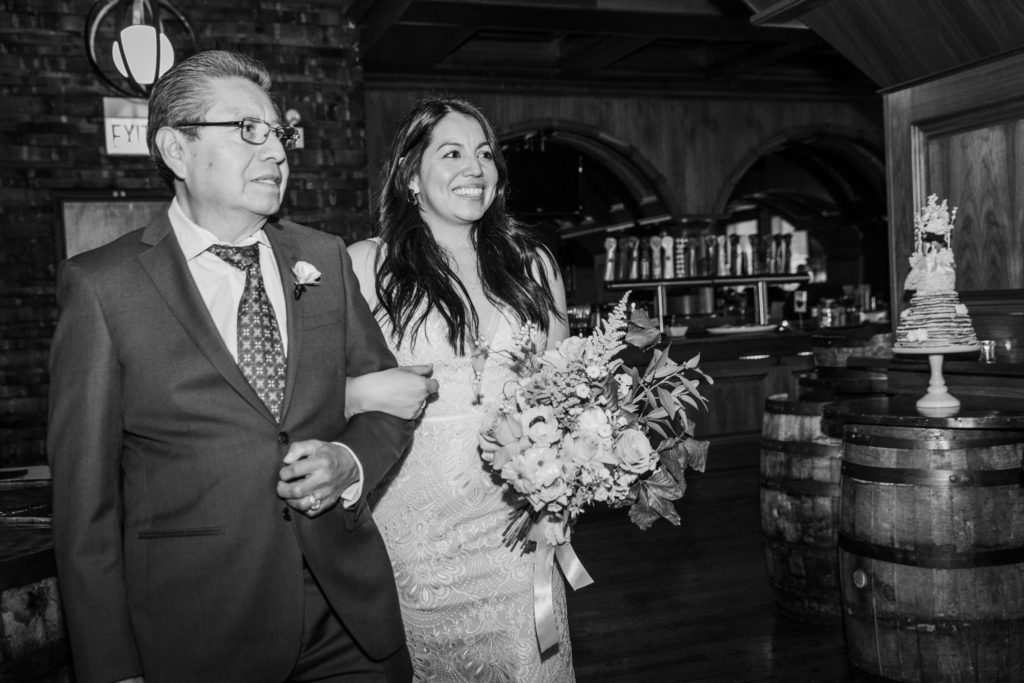 Bride walks with her father at her Revolution Brewing Wedding