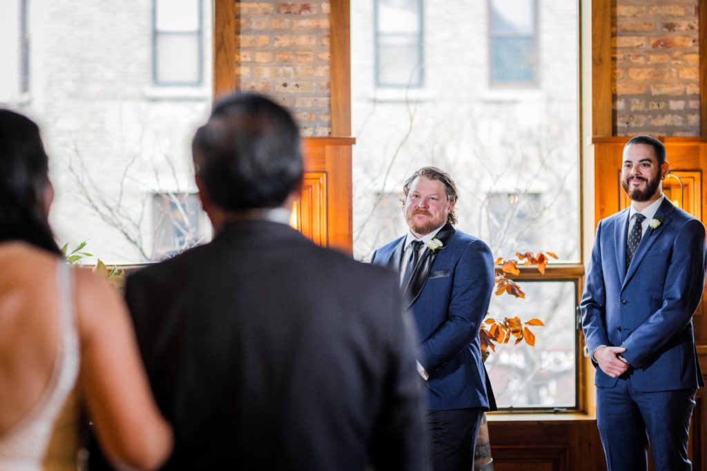 Groom watches bride walk down the aisle at his Revolution Brewing Wedding