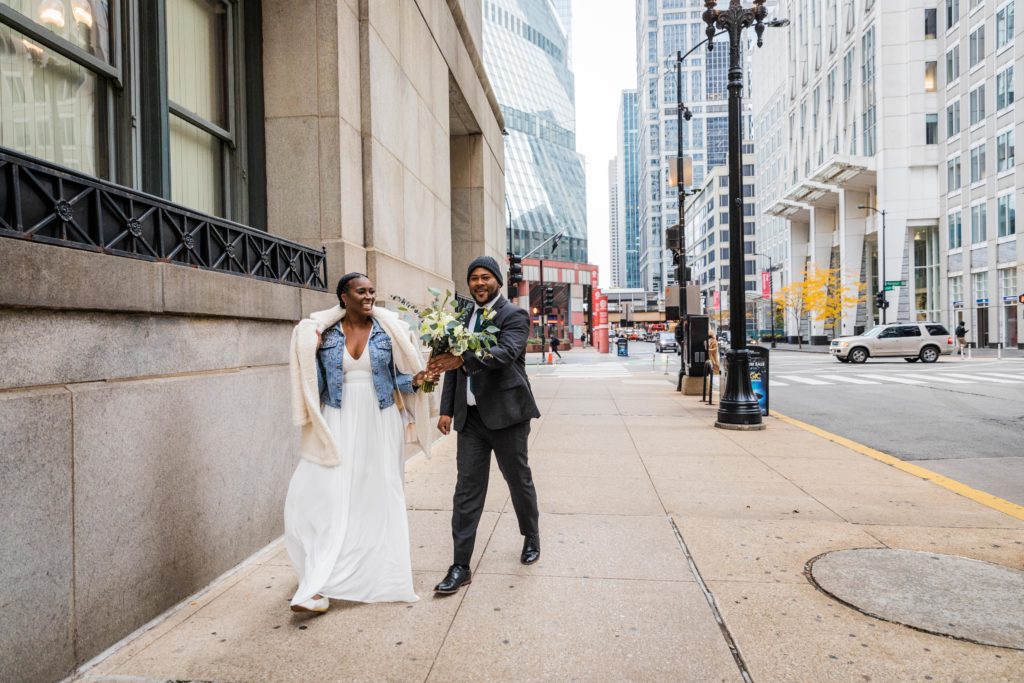 Couple walks downtown before their Chicago city hall wedding