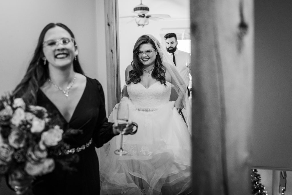 Bride and her friends laugh as they walk down the stairs before the wedding at Starved Rock