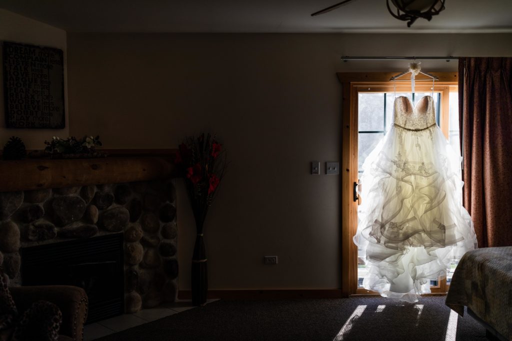 Bride's wedding dress hangs in the window before the wedding at  Starved Rock