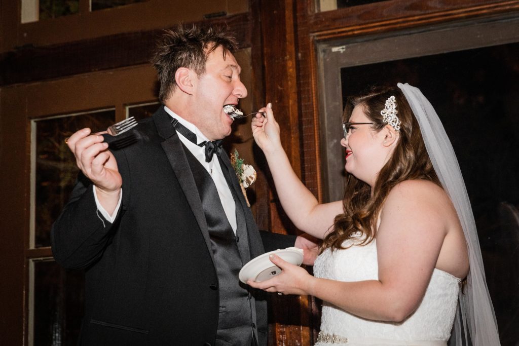 Bride feeds cake to her husband
