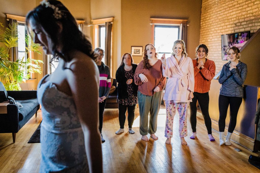 Bridal party reacts to seeing the bride for the first time
