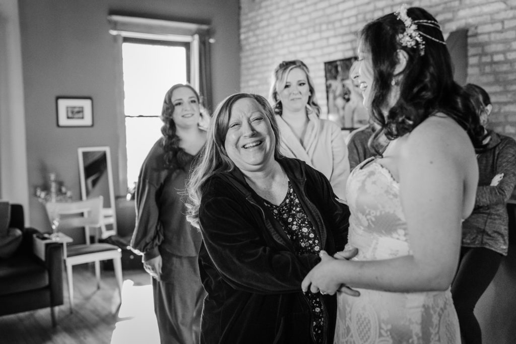 Mom laughs with the bride