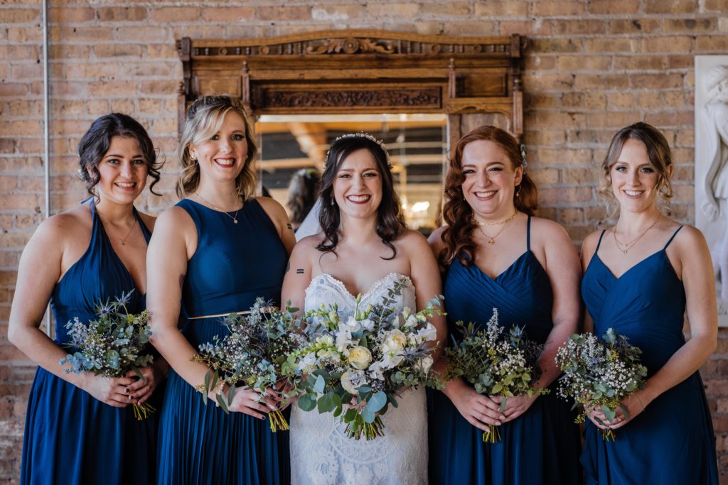 Bridesmaids pose with the bride at Salvage One