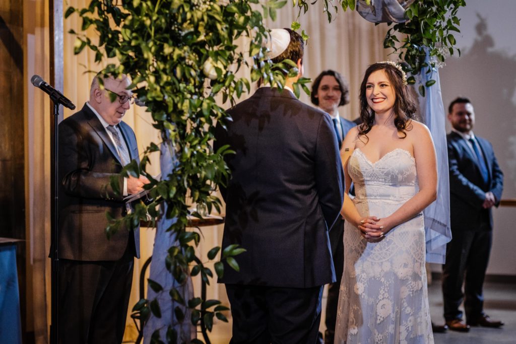 Bride looks at groom during their Ovation Chicago wedding ceremony