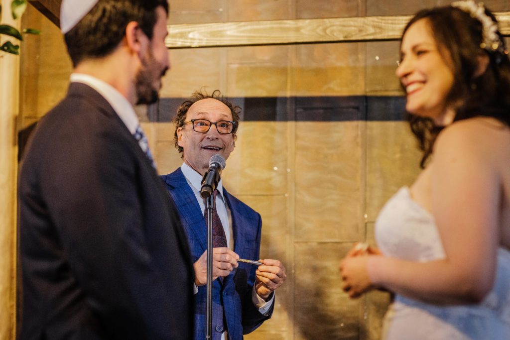 Groom's uncle laughs while performing wedding ceremony at Ovation Chicago