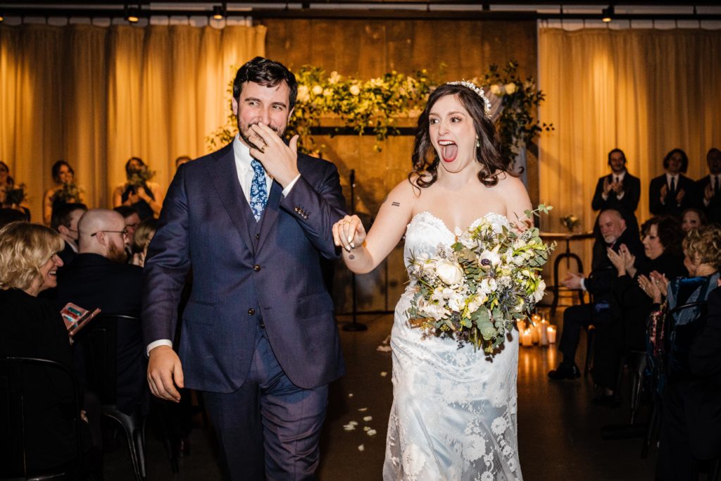 Bride and groom walk back up the aisle at Ovation Chicago