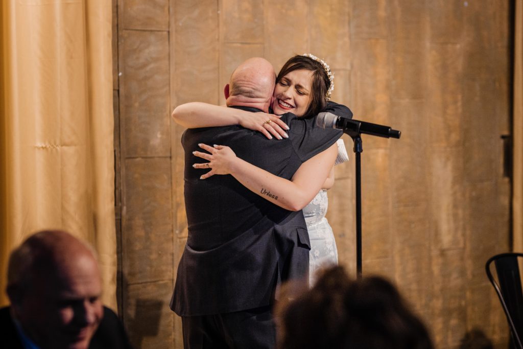 Bride hugs her father after he makes a speech at Ovation Chicago