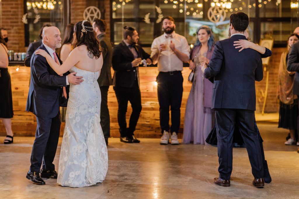 Bride and groom simultaneously dance with their parents at Ovation Chicago