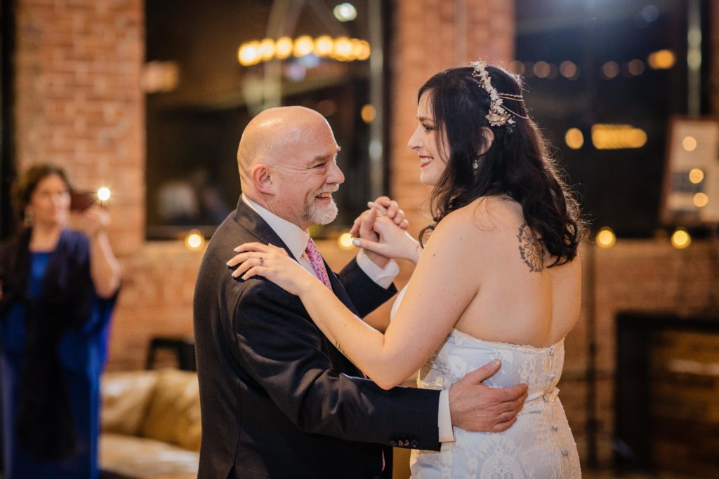Bride smiles while dancing with her dad at Ovation Chicago