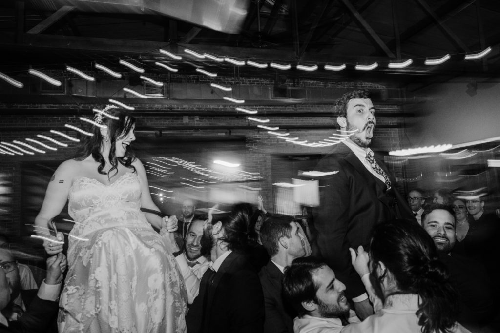 Bride and groom scream during the hora during their wedding at Ovation Chicago