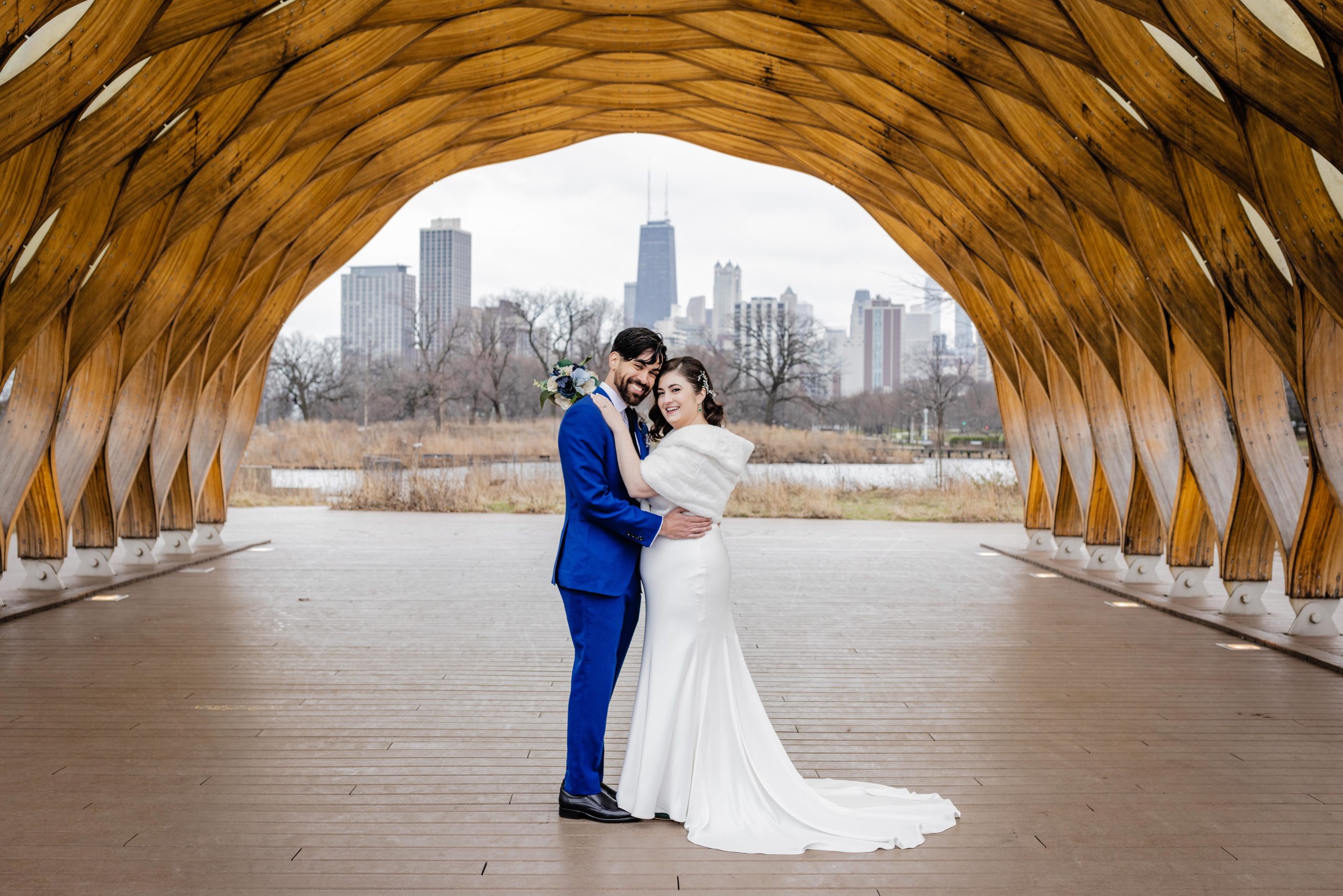 Couple posing under the Honeycomb in Lincoln Park before their Revolution Brewing Wedding