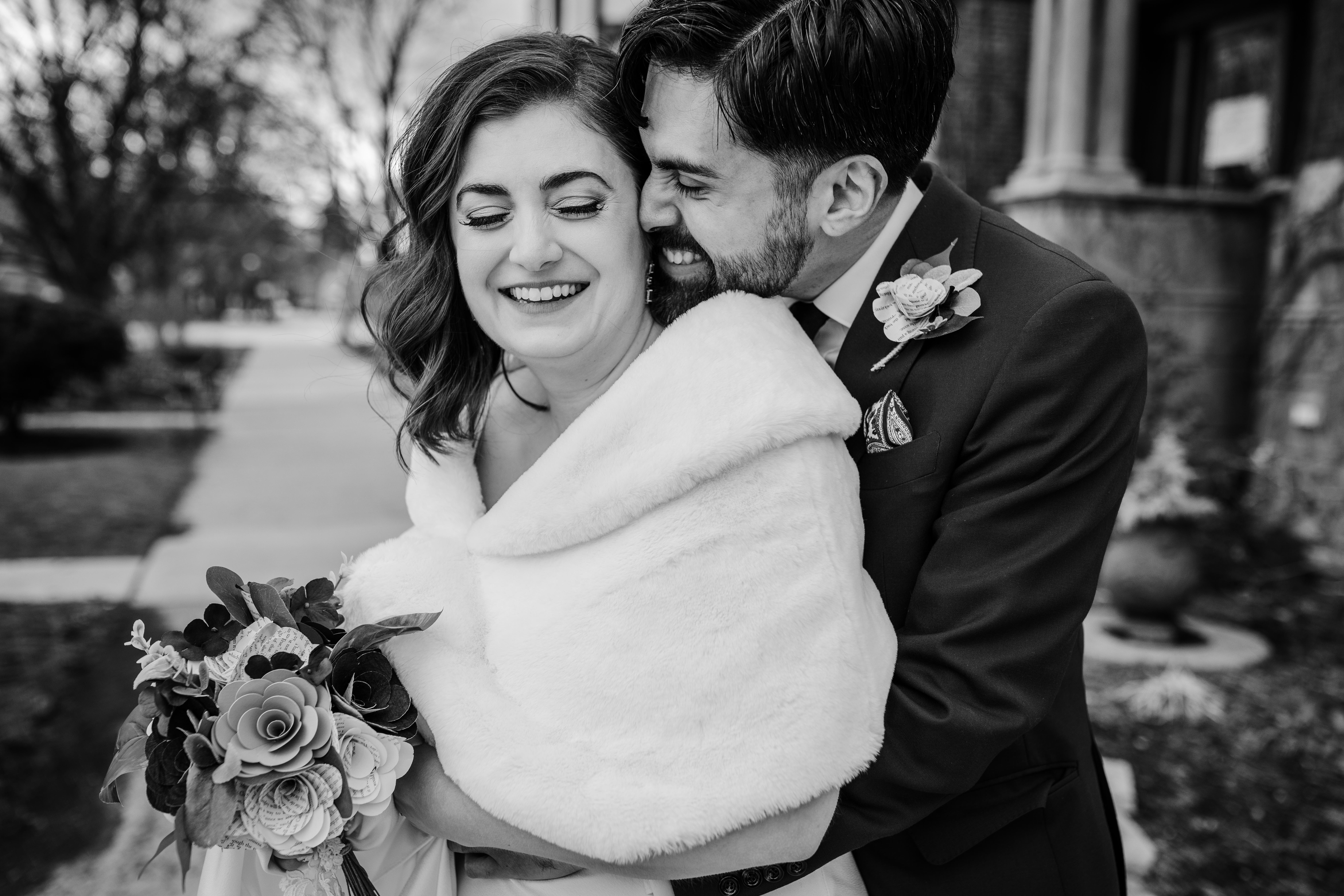 Couple snuggling in Logan Square before their Revolution Brewing Wedding 
