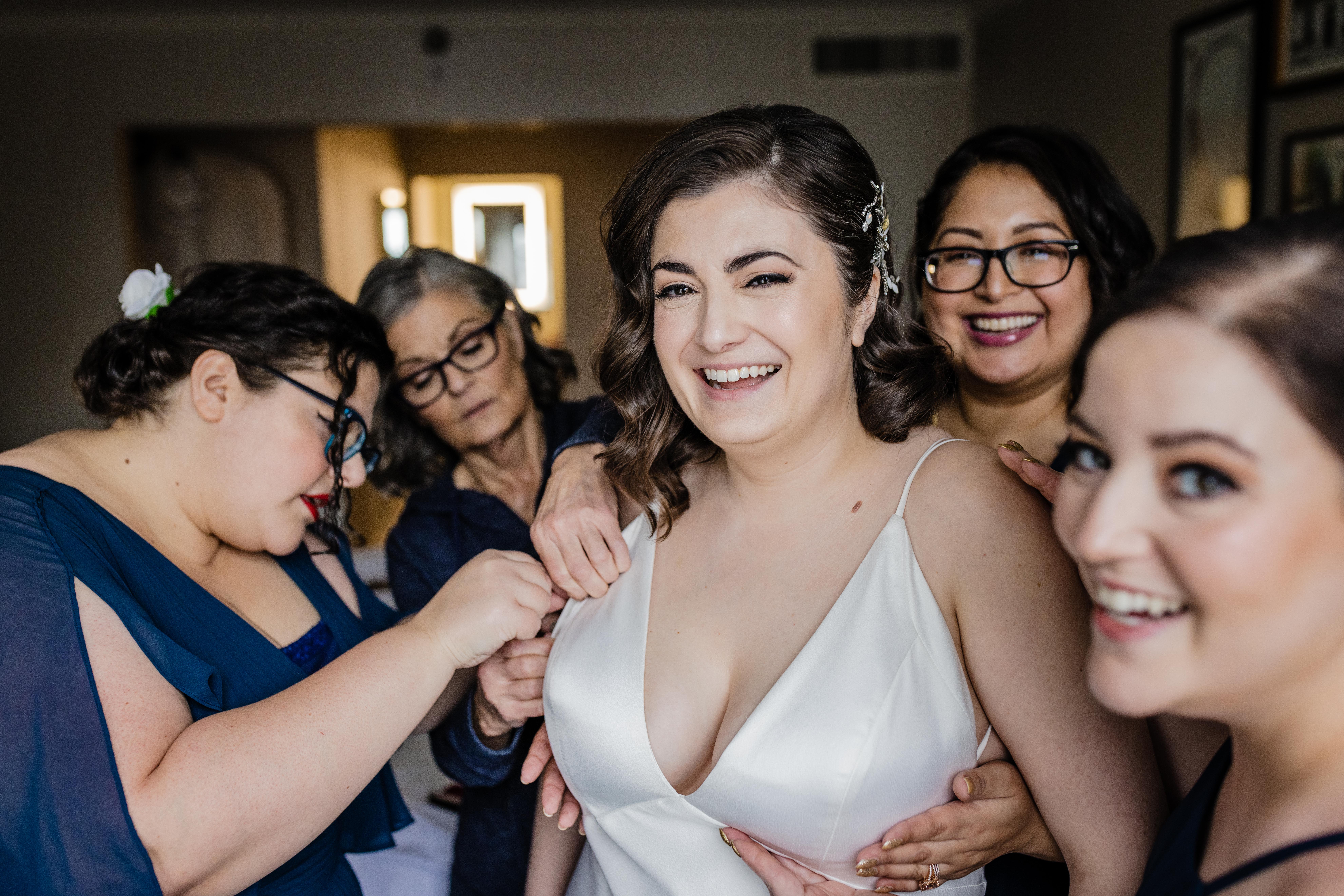 Bride laughing with her bridesmaids before her Revolution Brewing Wedding