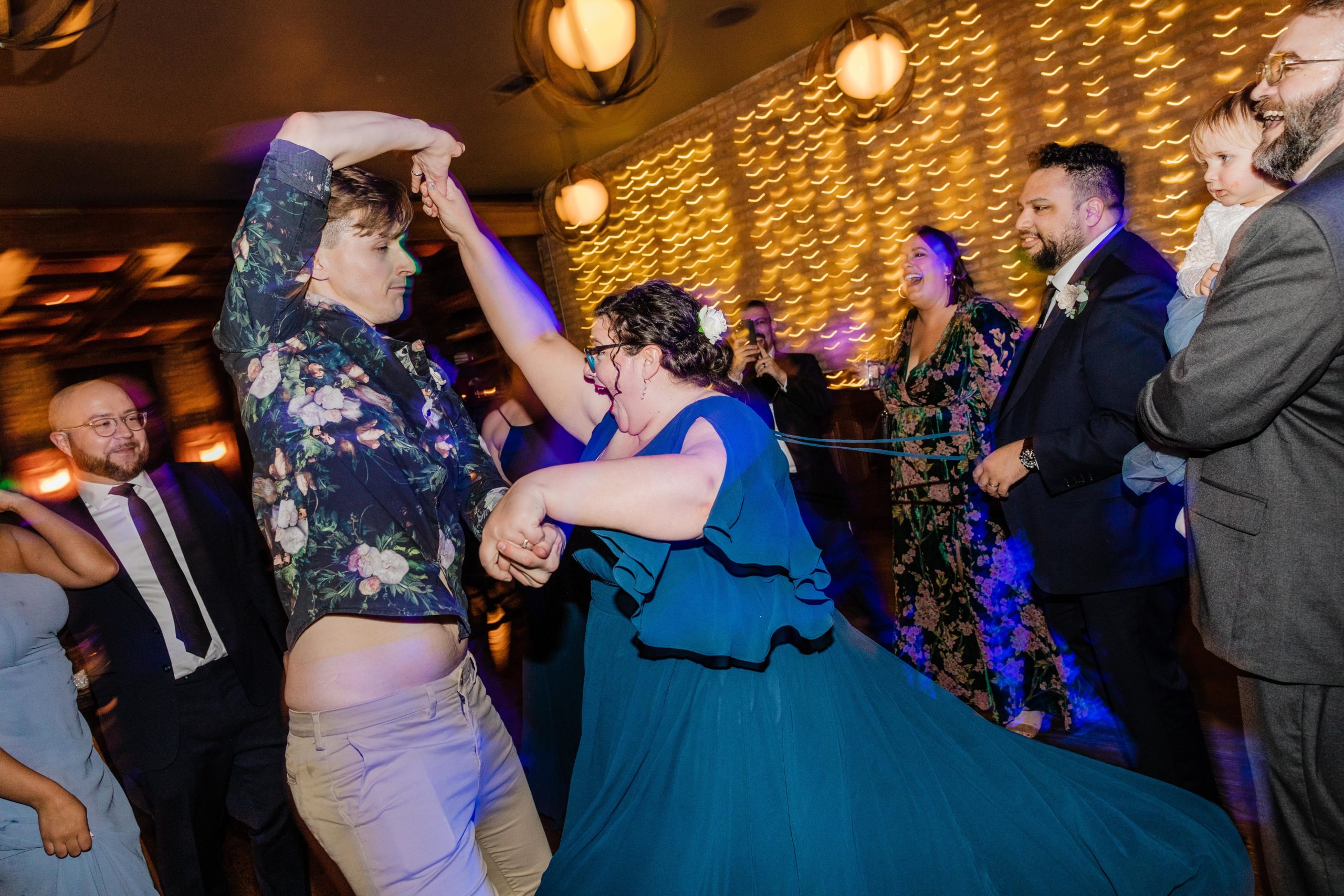 Bridesmaid dancing with officiant at a Revolution Brewing Wedding
