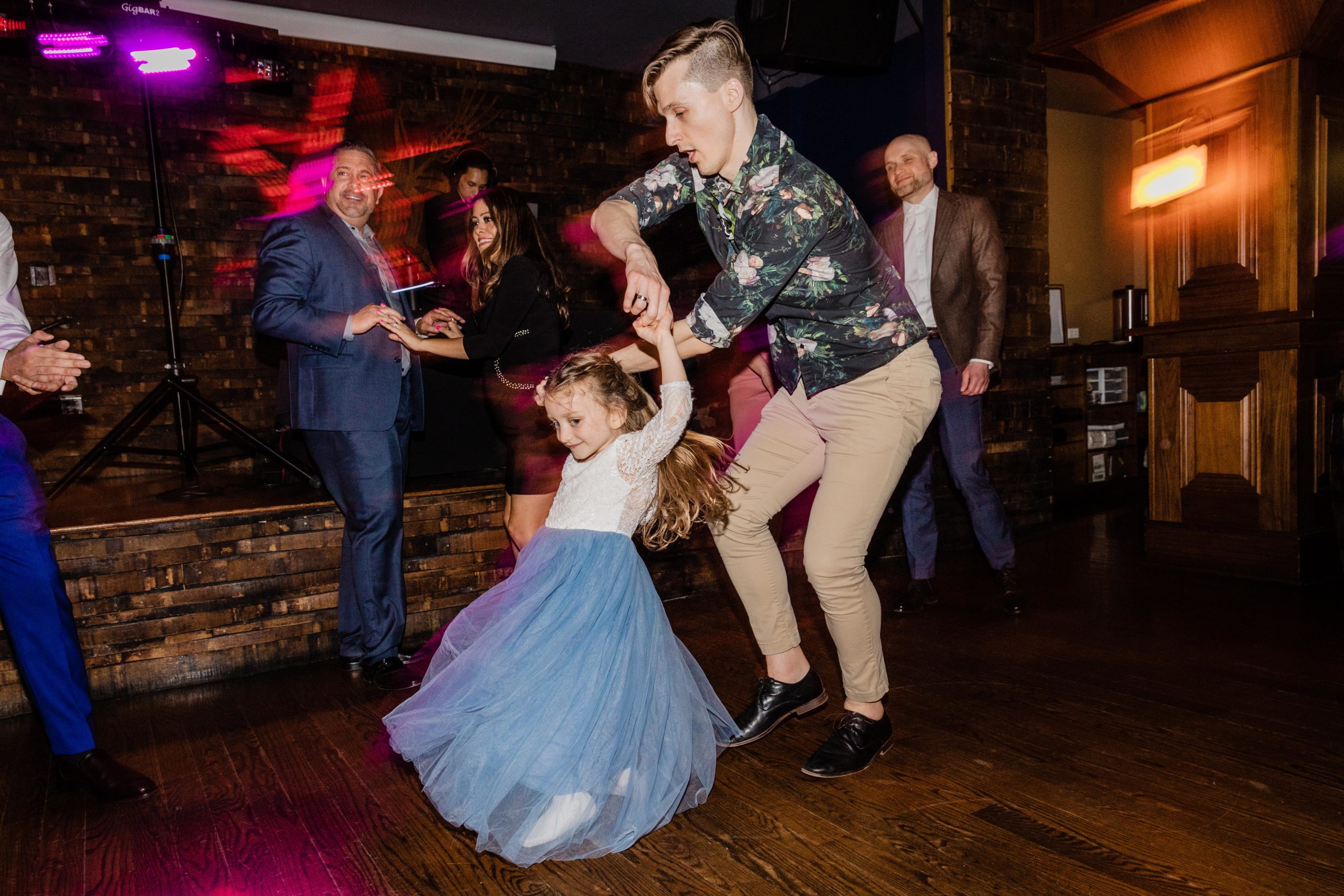 Bride's niece being spun on the dance floor at a Revolution Brewing Wedding