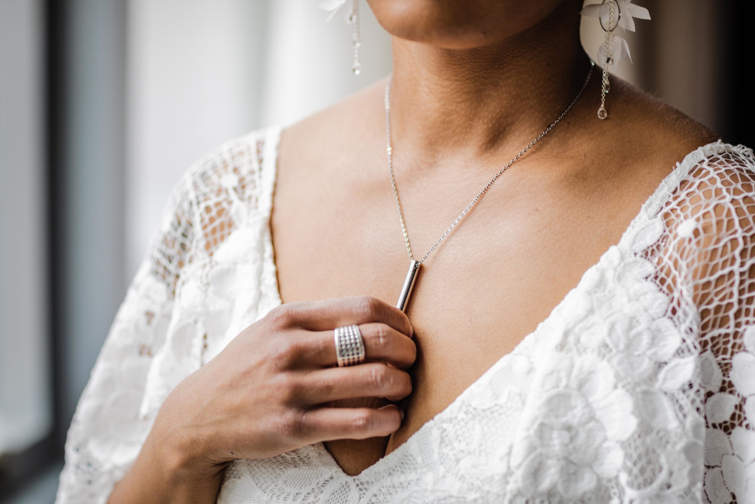 Bride holding necklace before her Bottom Lounge wedding