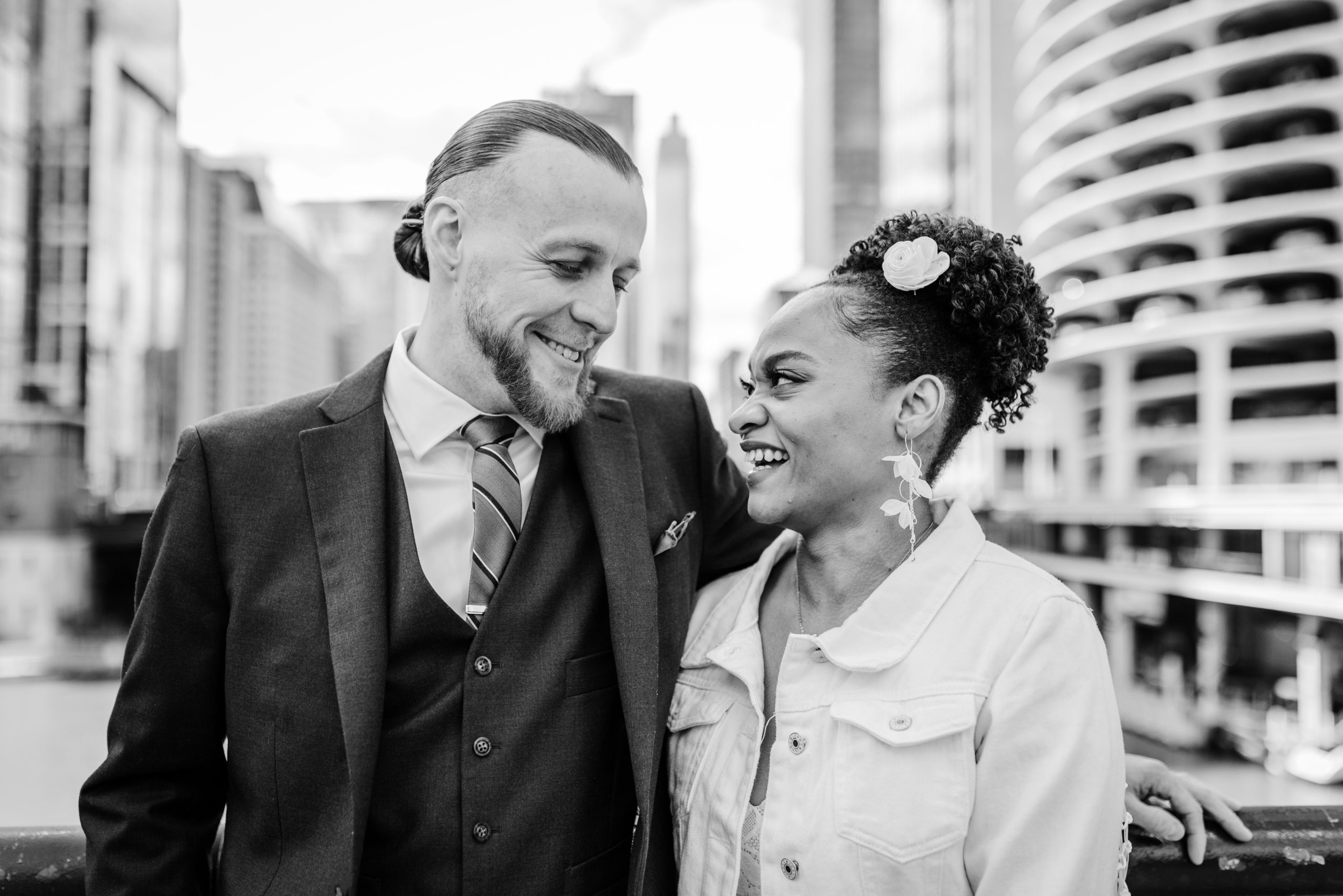Couple smiling at each other on a bridge before their Bottom Lounge wedding