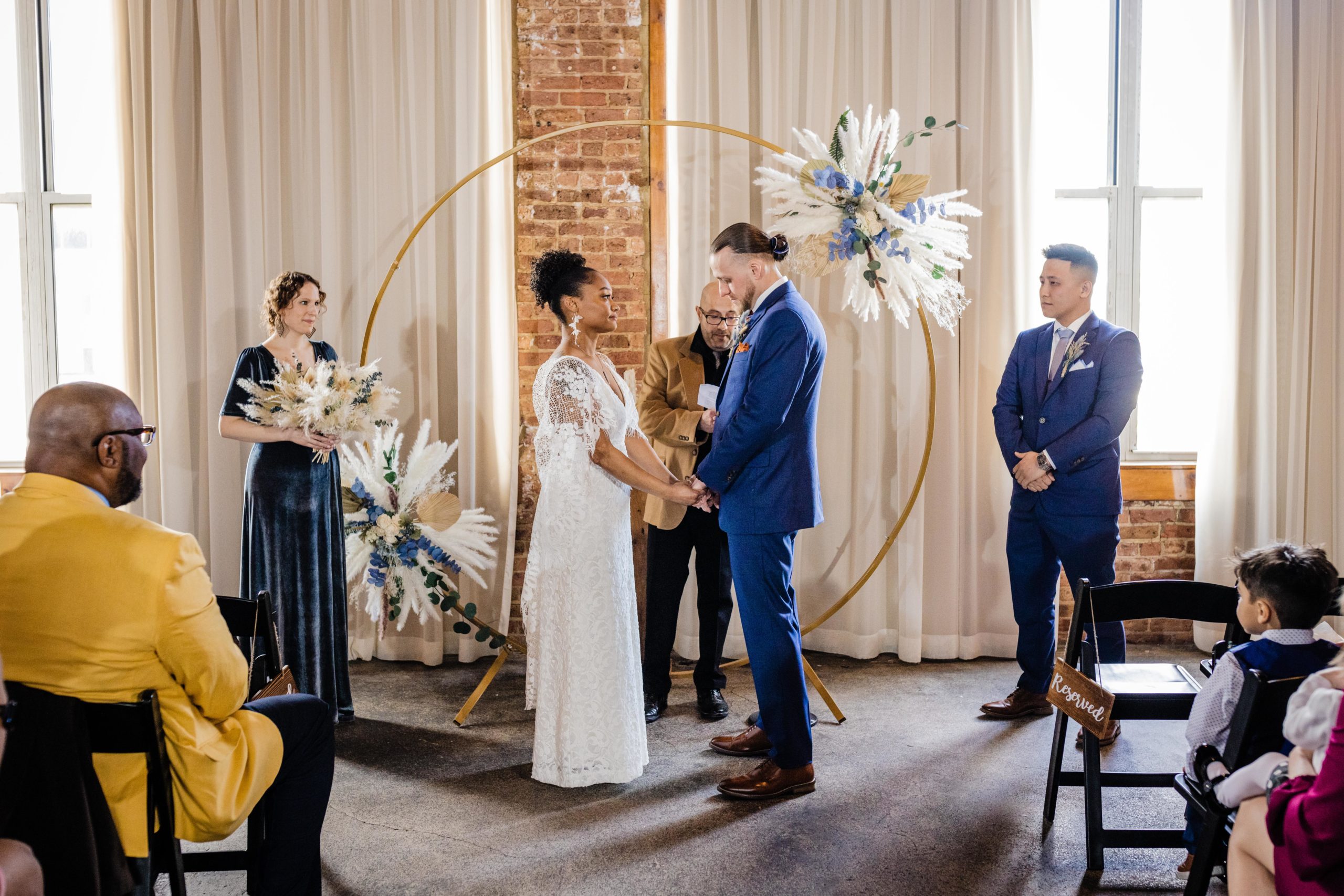 Couple facing each other during their Bottom Lounge Wedding ceremony