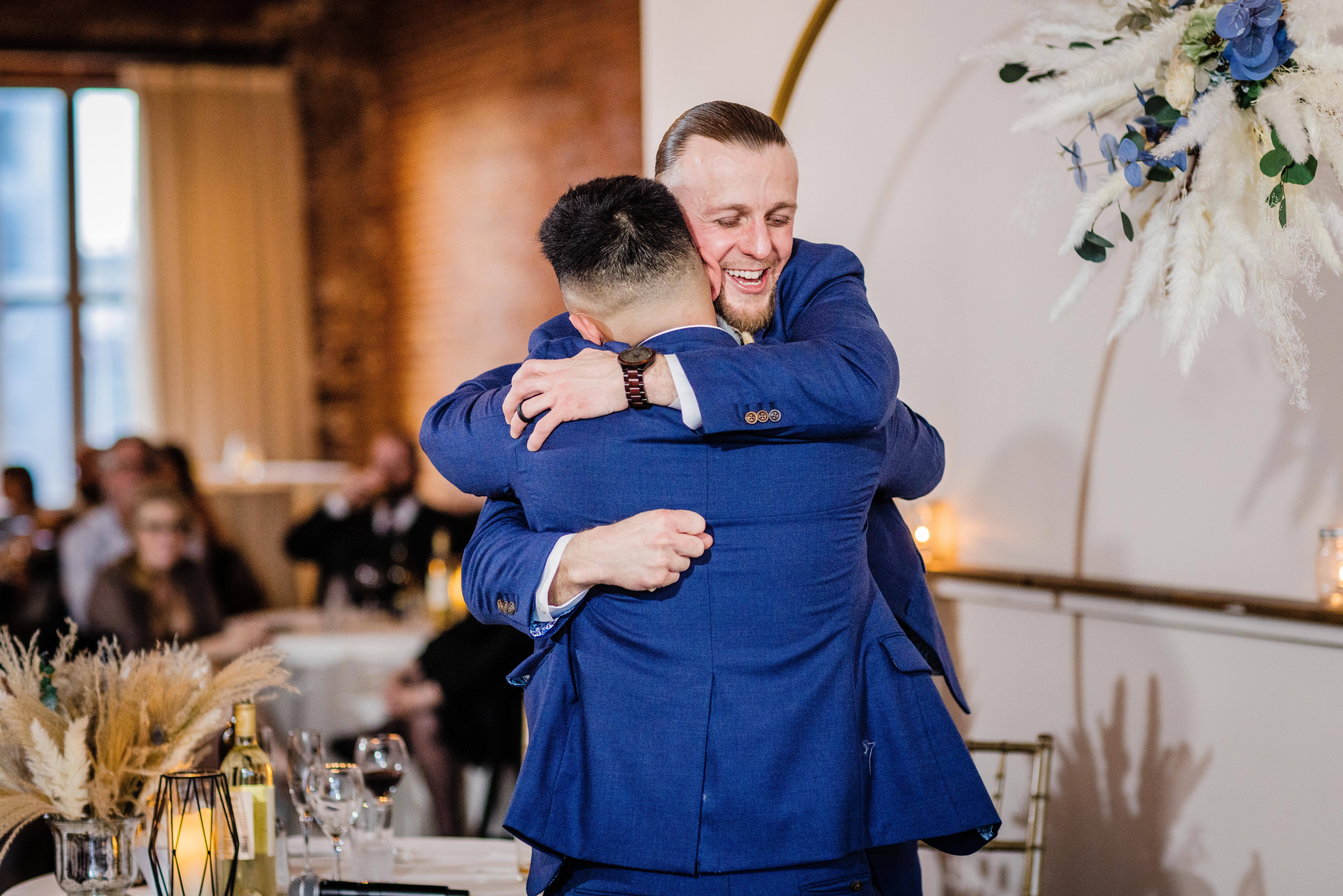 Groom hugging the best man at his Bottom Lounge Wedding