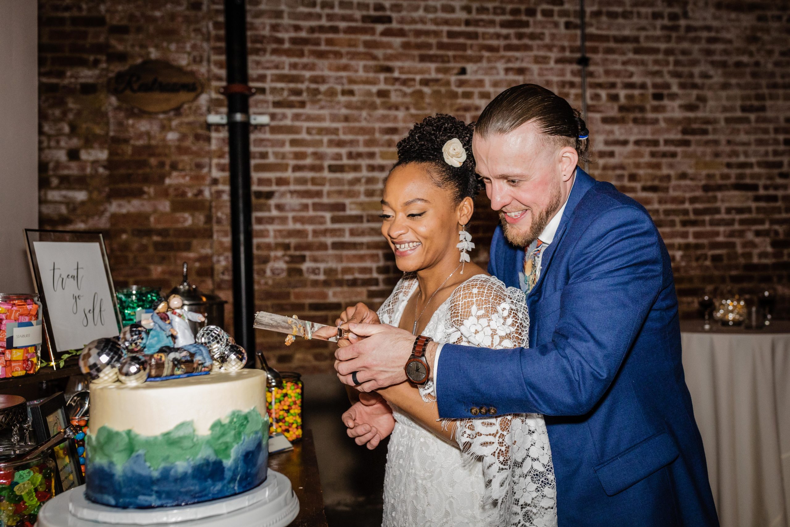 Bride and groom cutting the cake during their Bottom Lounge Wedding