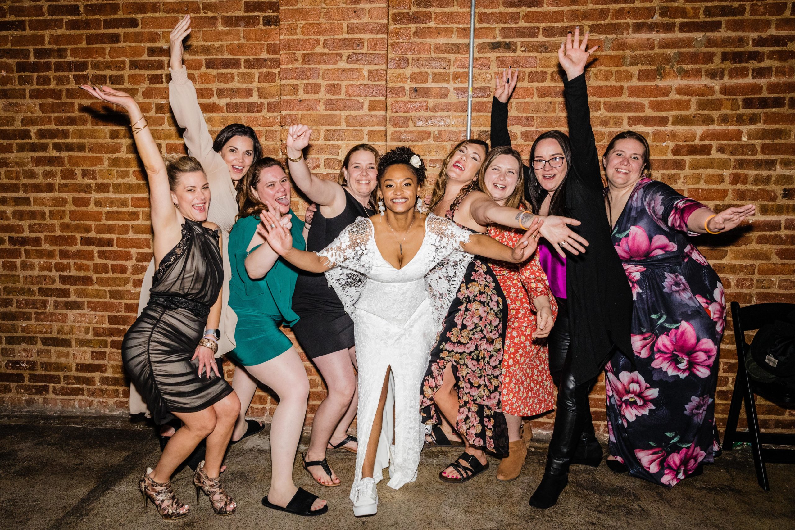 Bride posing with her childhood friends at her Bottom Lounge Wedding