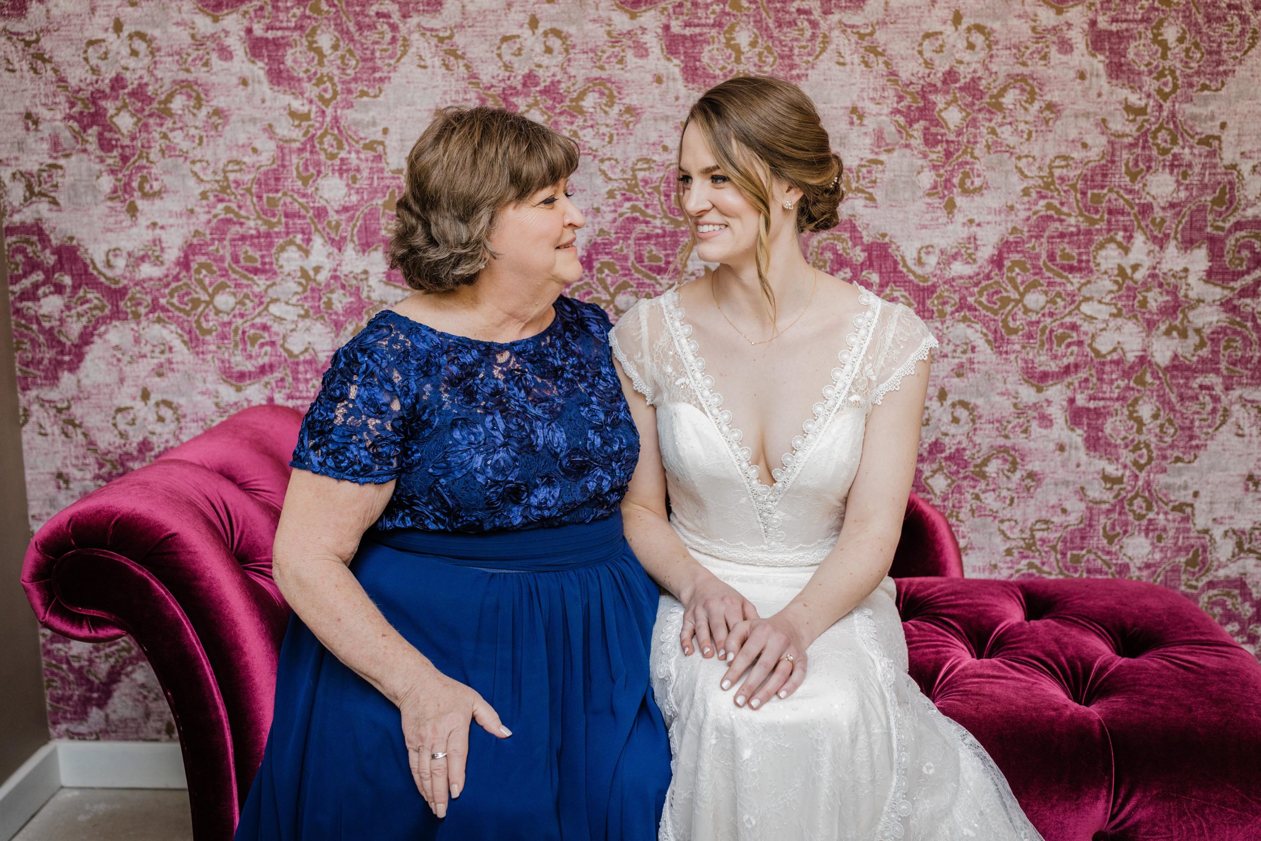 Bride and her mom looking at each other at the joinery